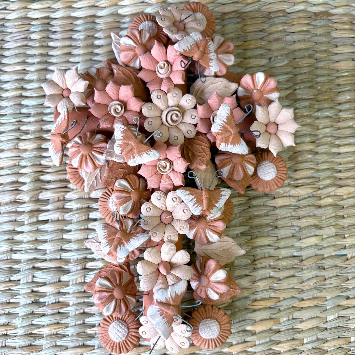 Decorative cross shape, made from artisanal seashell flowers, butterflies. It is designed as a delicate handcrafted piece of art or home decor
