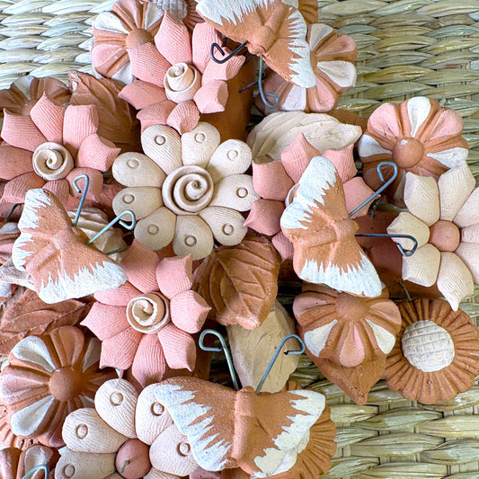 Decorative cross shape, made from artisanal seashell flowers, butterflies. It is designed as a delicate handcrafted piece of art or home decor