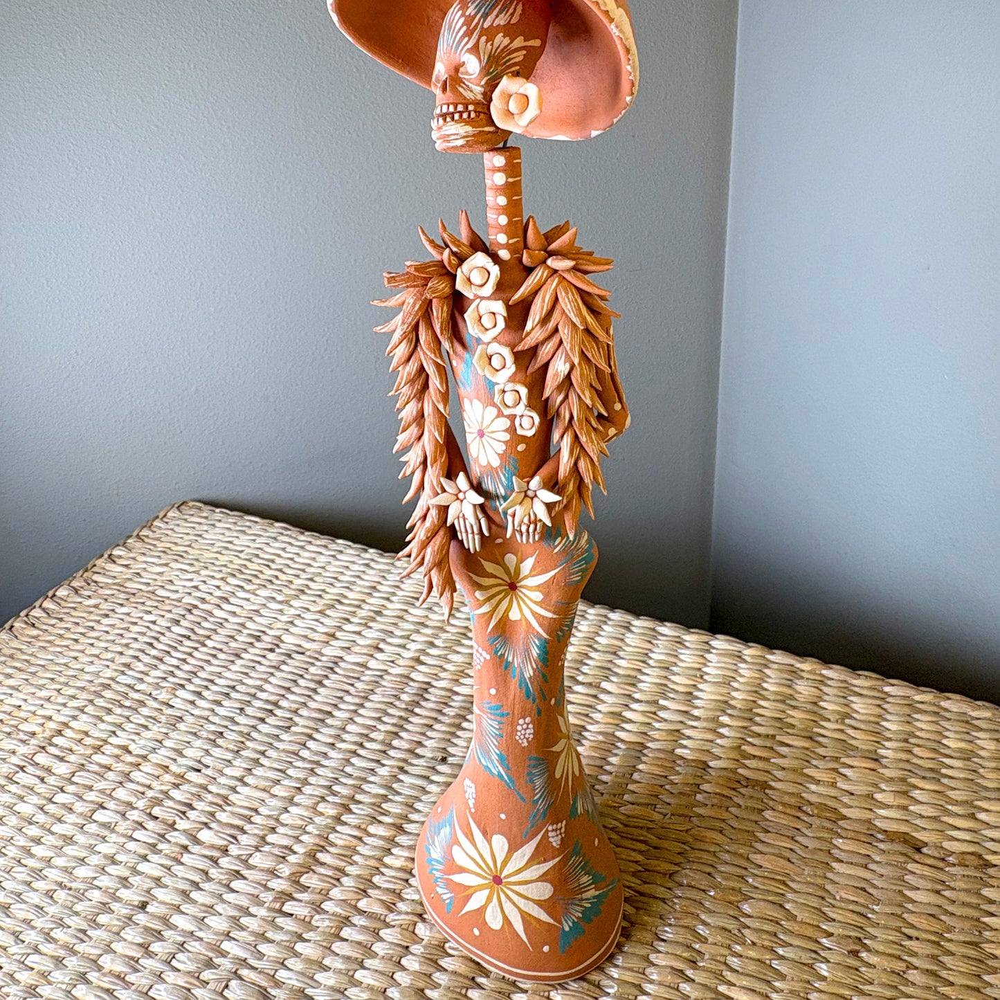 Catrine figurine. collectible item for the Day of the death, It is constructed from clay and features intricate, handcrafted detailss such as a large hat, sloral decorations, and hand-painted skeleton face