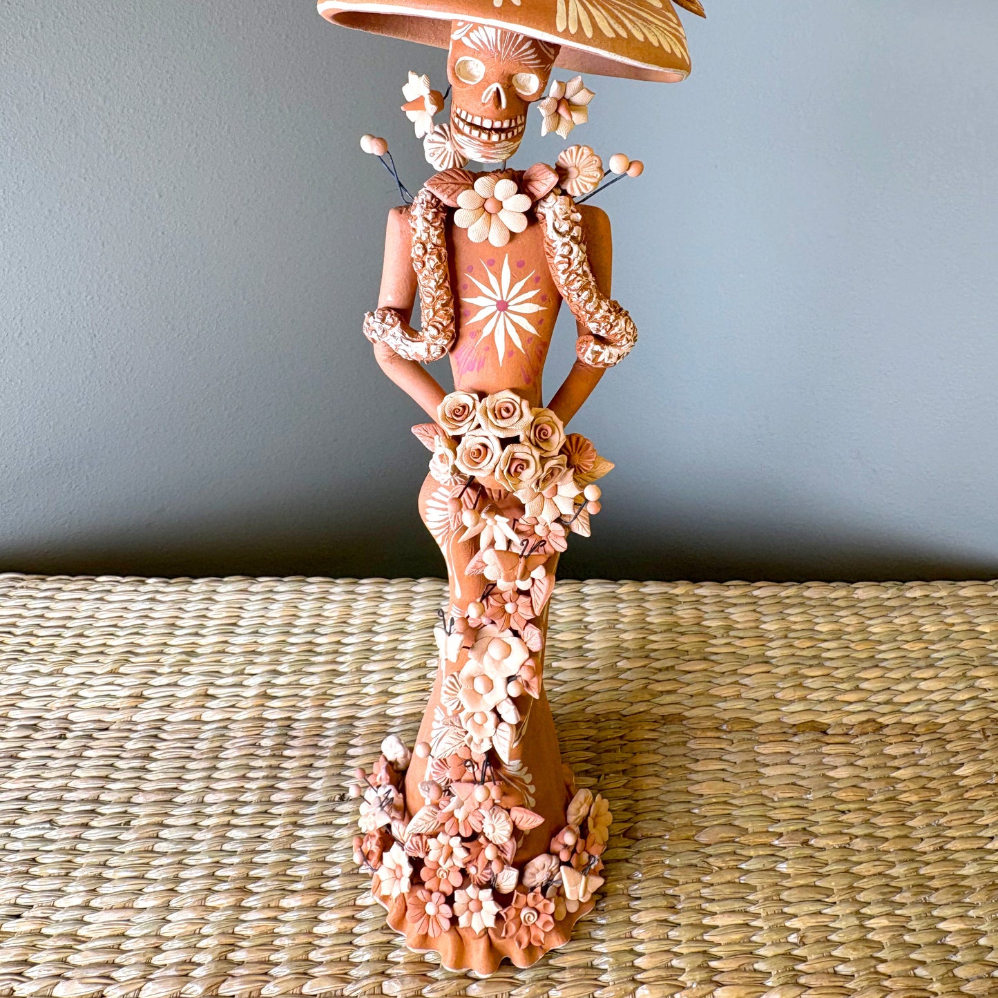 Catrine figurine. collectible item for the Day of the death, It is constructed from clay and features intricate, handcrafted detailss such as a large hat, sloral decorations, and hand-painted skeleton face