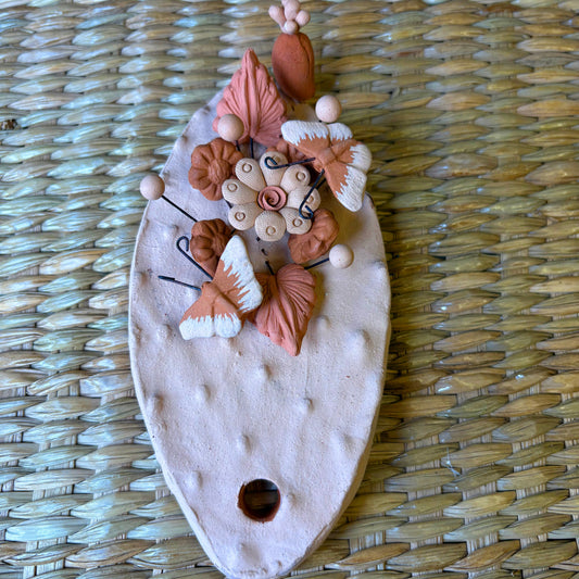 Handcrafted clay "Cactus" with decorative flowers and butterflies in earthy tones
