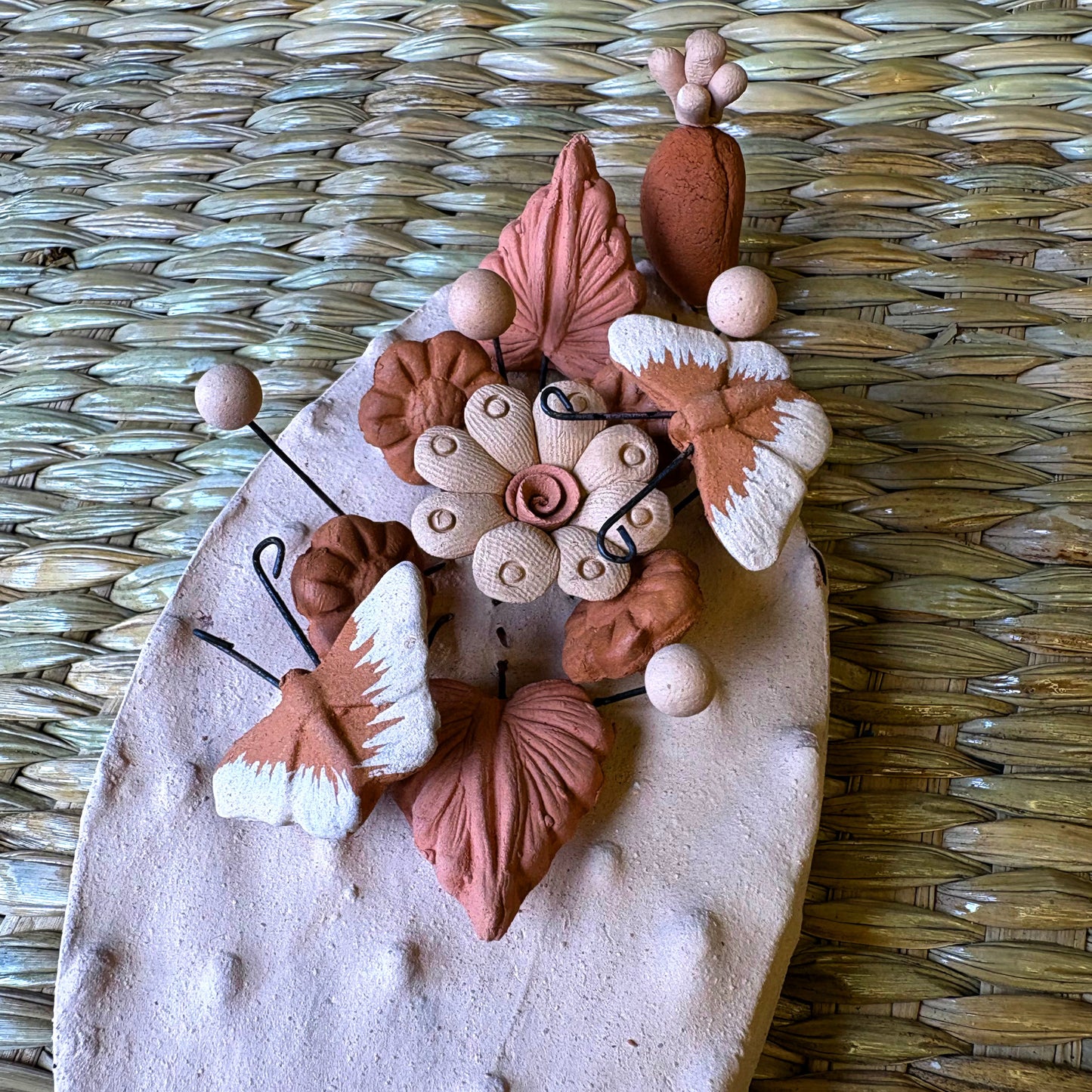Handcrafted clay "Cactus" with decorative flowers and butterflies in earthy tones