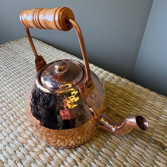 Copper tea kettle. can be used functionally on stovetops or as a deorative piece in home decor.