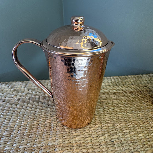 Hammered copper water pitcher (or jug) .