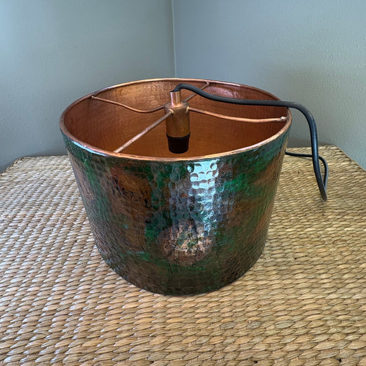 Decorative hammered lamp base with a patina finish.