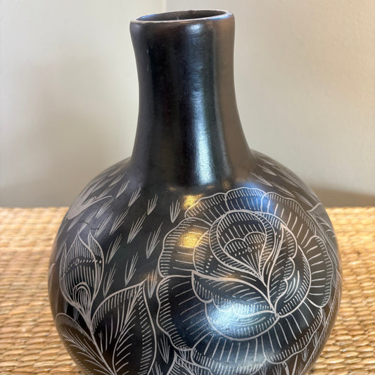 The black "pitcher" , hand made with out of clay, hand painted with flowers and burnished to shine.Accompanied by a matcing glass