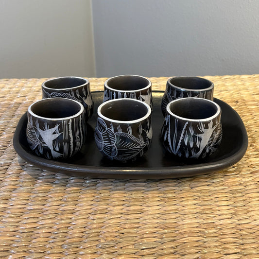 Handcrafted black pottery cups, specifically identified as "Mezcaleros". Comes with 6 pieces of mezcaleros  plus a beautiful tray made with clay.(SET)
