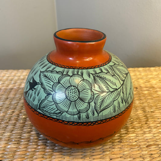 Handcrafted vessel from Michoaacan-Mexico. Featuring intricate hand-painted floral designs on a red clay, in turquoise color, Natural burnishead, traditional decorative vase.