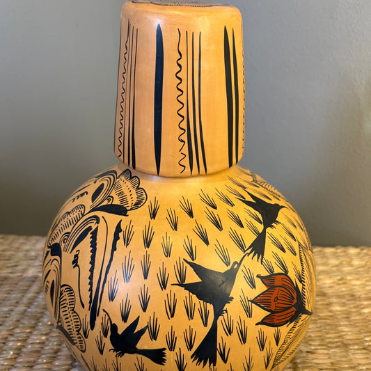 Decorative handpainted gourd pot , featuring a yellow base ith black birds and orange floral designs, This set is the vase plus the match glass. Used also for a jug drinking water